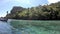 The Video moves from left to the right  side of the Boats parked in the sea and tourists are diving in the beautiful crystal clear