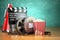 Video, movie, cinema vintage production concept. Film reels, clapperboard, tickets, popcorn and megaphone.