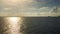 Video ocean sky horizon small boat sailing in setting sun light