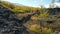 Video panorama of North Chuiskiy Ridge with stones on foreground and larch forest on background in Autumn. Altai