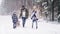 Video of parents with children walking in frozen winter forest.