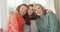 Video portrait of happy caucasian mother, grandmother and granddaughter embracing on couch