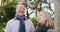 Video portrait of happy caucasian senior husband and wife talking and smiling in autumn garden