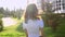 Video portrait teenage girl wearing glasses walking in the park shaking hair