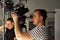 Video production backstage. Behind the scenes of creating video content, a professional team of cameramen with a