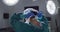 Video of rear view of asian female surgeon tying face mask in operating theatre