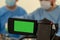 Video recording and live broadcast of the work of two surgeons. Operating room surgical hospital. Green screen camcorder. Copy