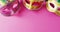 Video of three pink and gold carnival masquerade masks on pink background with copy space