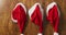 Video of three santa hats hanging in a row on wooden background