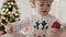 Video of toddler unwrapping tiny Christmas gift.