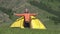 Video of tourist man in camp. Tourist climbs out of the tent and stretches. Camping in Altai mountains