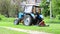 Video tractor mows grass on a lawn in a residential area