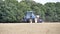 Video of tractor rotovating field of stubble and planting seeds