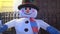 A video useful to express a concept about winter, snowman, church, cheerfulness, or festivity.