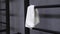 This video is about White towel is hanging on the black wall bars in gym