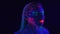 Video of woman with bright bodyart in ultraviolet light