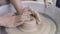 Video Women's hands make a plate of clay on a potter's wheel.