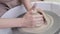 Video Women's hands make a plate of clay on a potter's wheel.