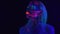 Video of young girl with bright bodyart in ultraviolet light