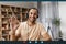 Videocall screenshot of cheerful arab man in headset having web conference, waving hand at camera and smiling