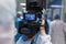 Videographer, dressed in sterile white clothes, records what is happening in the medical laboratory.