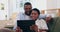 Videos, tablet and black couple laugh on sofa for bonding, relationship and relax together in home. Love, marriage and