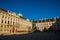 Vienna, Austria: Hofburg palace and panoramic square view, people walking and fiaker with white horses in Vienna, Austria