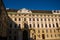 Vienna, Austria: Hofburg palace and panoramic square view, people walking and fiaker with white horses in Vienna, Austria