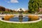 Vienna, Austria - October 2021: Fountain in Volksgarten park with Burg theater at background