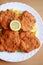 Vienna food - Wiener Schnitzel with french fries and slice of lemon, fried pork chop,FiglmÃ¼ller Schnitzel & Frittaten