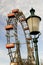 Vienna prater park amusement giant wheel with red cabins. from ground with a blurred street lamp