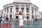 Vienna State Theater Burgtheater, Austria. A girl in a pink dress stands on the background of the building.