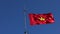 Vietman flag blowing in hard wind against clear blue sky