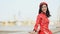Vietnam girl in the national red dress Ao Dai posing and smiling for the camera
