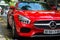 Vietnam, Hanoi, December 06, 2016: Red supercar Mercedes GTS on a street of city. Fragment of exterior of car