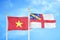 Vietnam and Herm two flags on flagpoles and blue sky