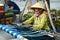 VIETNAM, HO CHI MINH - Vietnamese Woman Weaving Yarn On Street