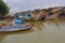 Vietnam, Hoi An - January 2017: Boat floats on Bon River against the backdrop of houses on the waterfront in the town of Hoi An