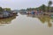 Vietnam, Hoi An - January 2017: Boat floats on Bon River against the backdrop of houses on the waterfront in the town of Hoi An