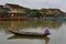 Vietnam, Hoi An - January 2017: Boat floats on Bon River against the backdrop of houses on the waterfront in the town of Hoi An