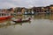 Vietnam, Hoi An - January 2017: Boat floats on Bon River against the backdrop of houses on the waterfront in the town of Hoi An