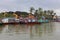 Vietnam, Hoi An - January 2017: Boat floats on Bon River against the backdrop of houses on the waterfront in the town of Hoi An