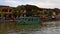 Vietnam, Hoi An - January 2017: Pleasure boat floats on Bon River against the backdrop of houses on the waterfront