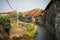 Vietnam landscape with old aged houses and woman cycling on road in village