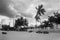 Vietnam. Seaside town, palm trees and clouds. Vietnamese round wicker boats on the shore. Black and white.