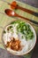 Vietnamese Chicken Soup with Glass Noodles Mien Ga closeup on the bowl. Vertical top view