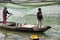 Vietnamese couple bringing buckets with shrimp catch to the dockside.