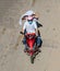 Vietnamese couple rides a motorbike