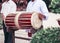 Vietnamese drum. The musician holds the drum and plays it.