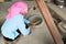 Vietnamese ethnic minority woman pounding rice to make glutinous rice flakes Com